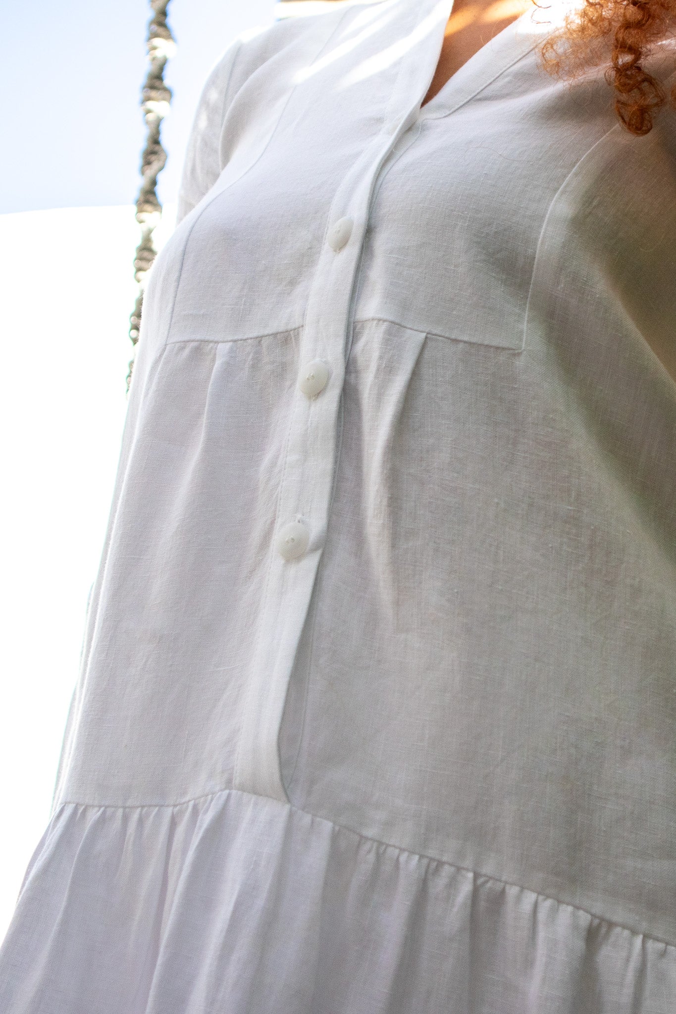 close image of white linen dress from Australian label The boy and I, showing the details