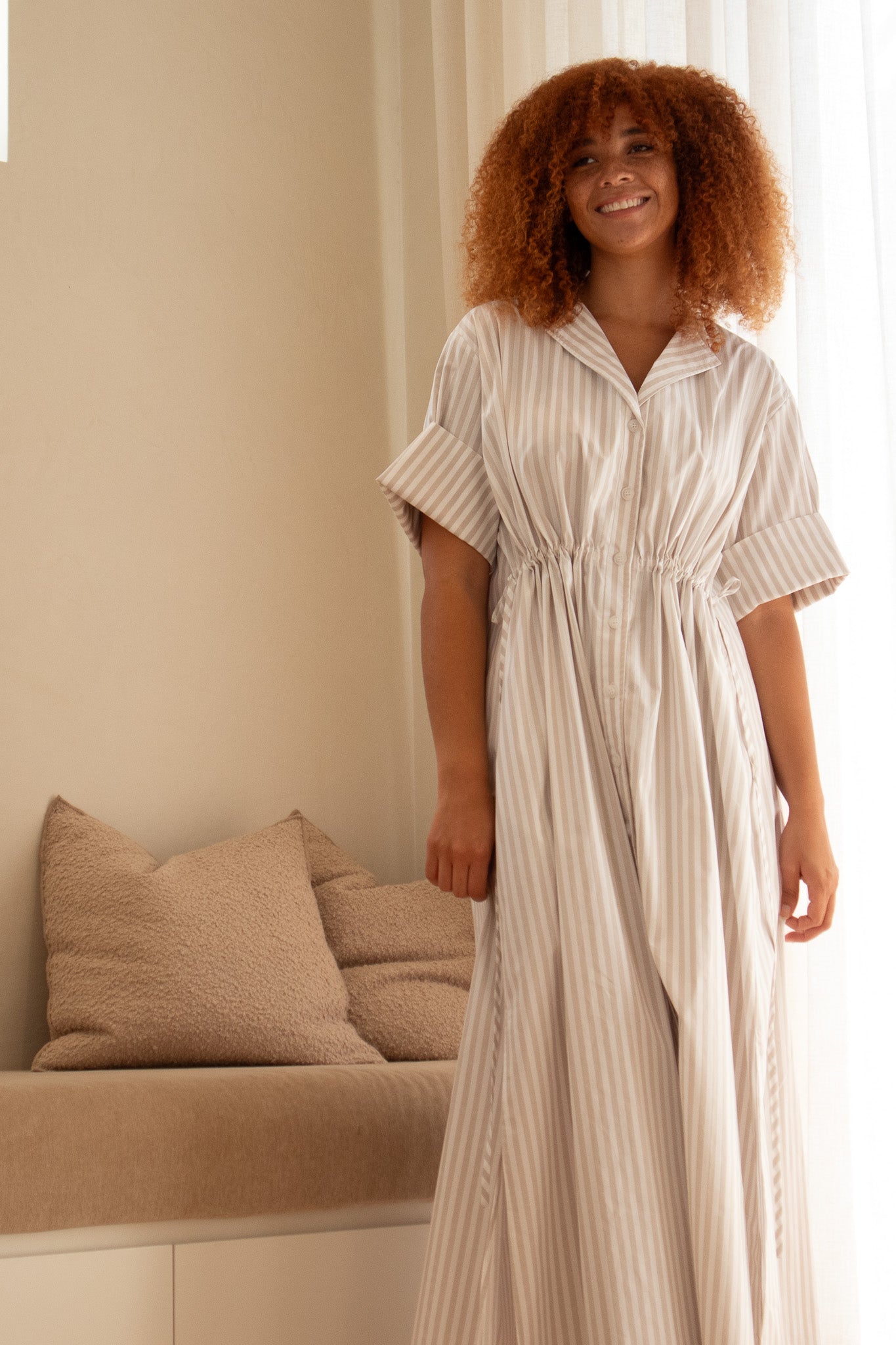 Model wearing beige stripe dress with drawstrings from Australian clothing label